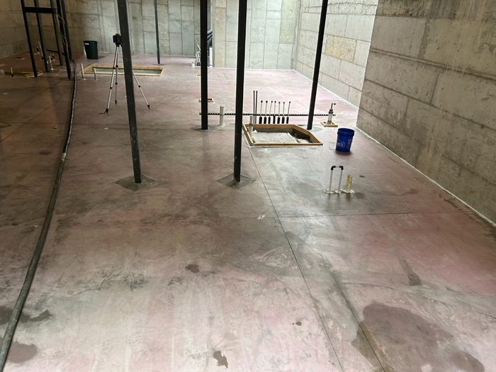 Primed slab with penetrations and openings boxed out ahead of the pour.