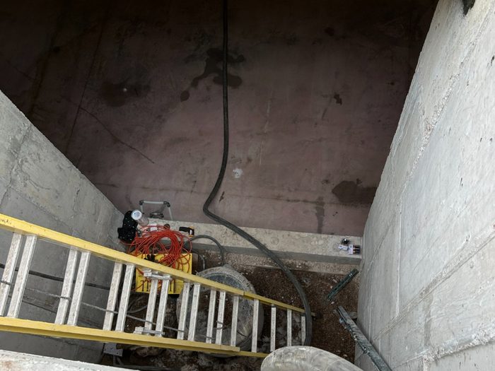 Delivery hose dropped through the opening down to the lower level.