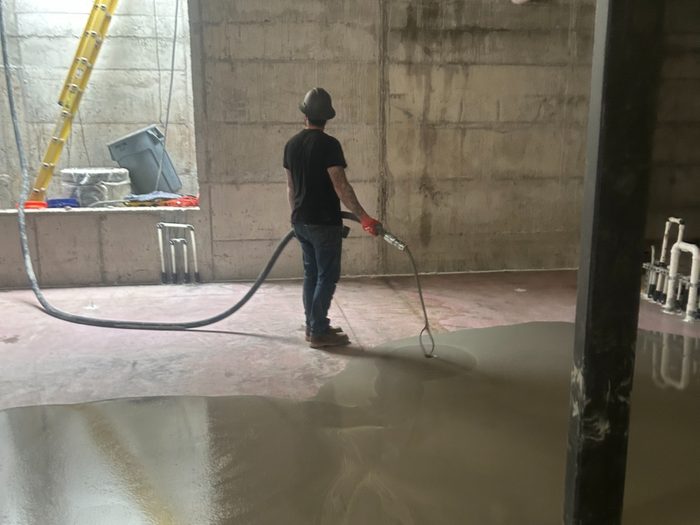 Self-leveler placed across the lower level, working out from the hose.