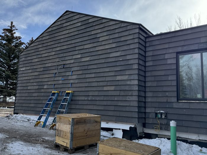 Near-complete gable field, ladders up for the final courses.
