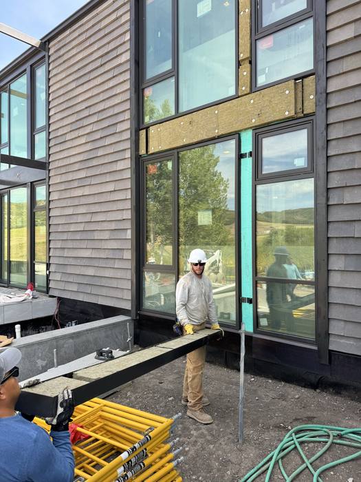 Raw steel mullions and framing at the interior-to-exterior interface.