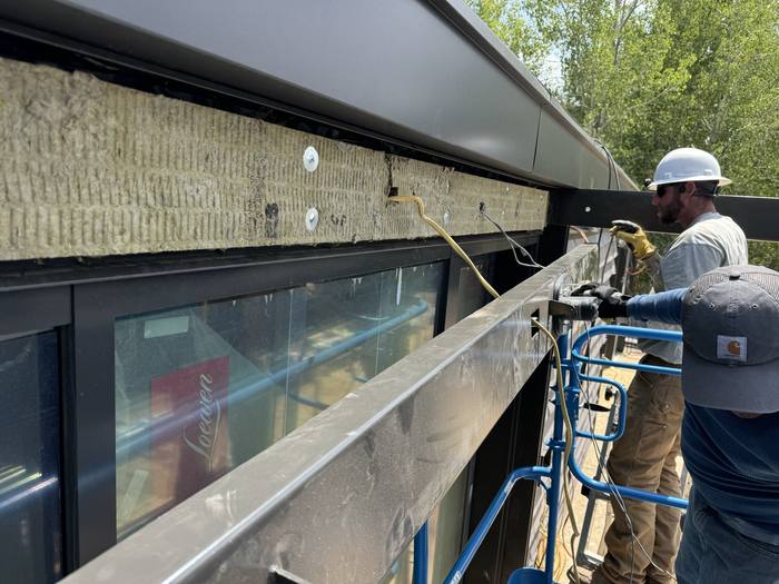 Insulation installed behind a steel frame section.