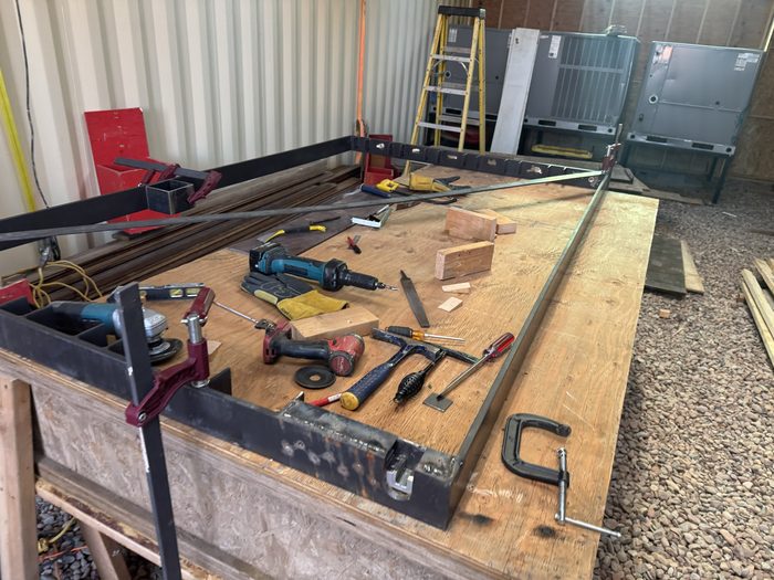 Welded steel frame squared and clamped on the bench.
