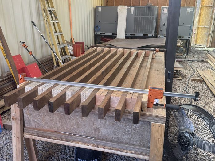 Slats laid out with precision spacers, ready to load into the frame.