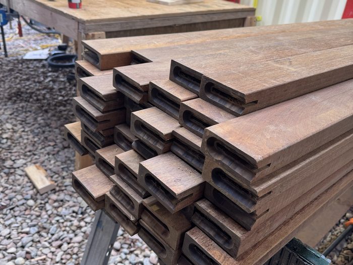 Hardwood slats staged on the sawhorse, ends routed to fit the frame.